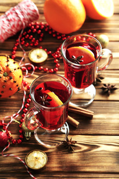Mulled wine in glass on brown wooden table