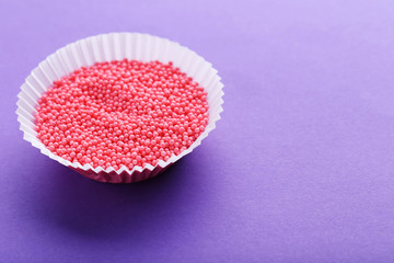 Colorful sprinkles on a purple background