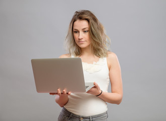 Smart beautiful young girl using laptop