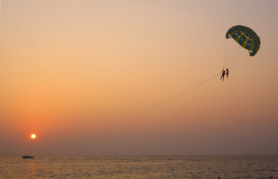 sea sunset with parashute and clouds