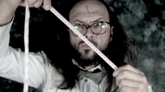 4k Crazy Professor Science Man Playing with a Measuring Tape