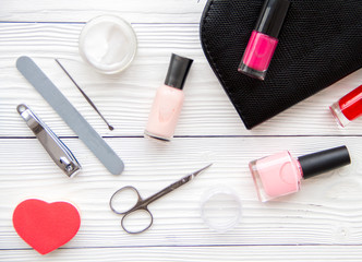 manicure set and nail polish on wooden background