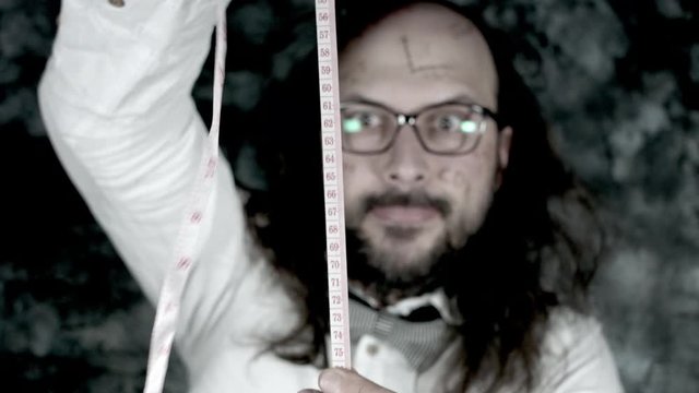 4k Crazy Professor Science Man Playing with a Measuring Tape