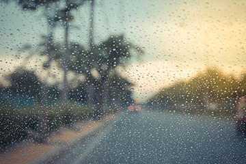 Car windscreen glass and rain water drops