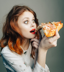 Woman with pizza. Pizza in the mouth. Woman eating pizza
