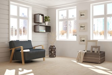 White room with armchair and urban landscape in window. Scandinavian interior design