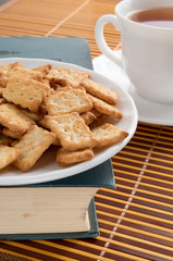 White plate with cookies on the old book