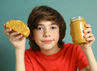 preteen boy hold peanut butter with nut pieces