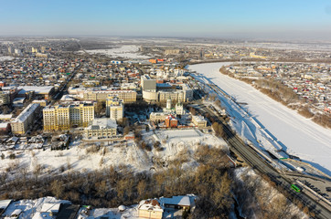 Obraz premium Tyumen, Russia - February 15, 2016: Aerial view onto Nikolsky Vzvoz, Krestovozdvizhensky temple, State architectural and construction university, Holy Trinity Monastery and Tura river quay