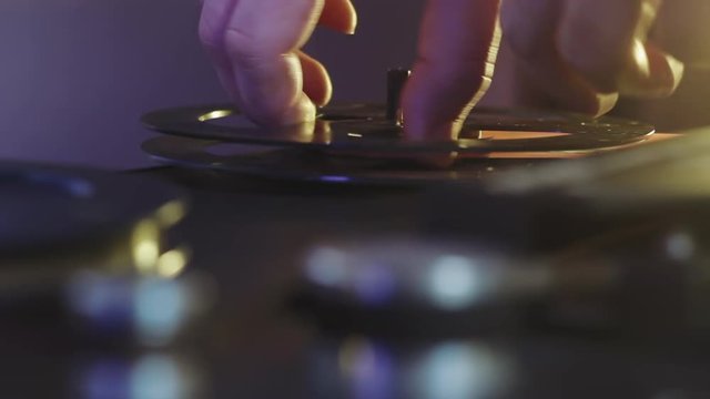 Man runs the tape to reel tape recorder at sound studio for music listing