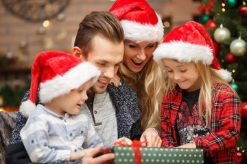 Parents with kids open gifts