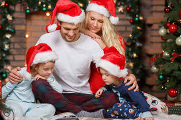 Parents with children reading book