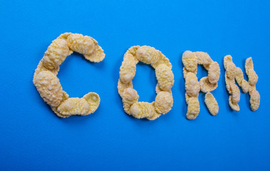 word of corn flakes on a blue background, lettering