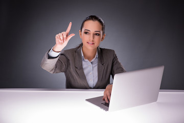 Businesswoman with laptop in business concept