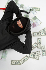 Winking burglar lies with money