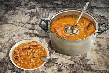 Baked Beans With Smoked Pork Ribs Dinner Served On Old Cracked Wooden Garden Table