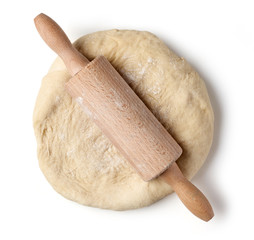 fresh raw dough and rolling pin