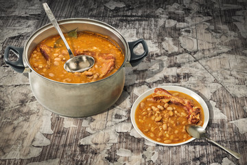 Baked Beans With Smoked Pork Ribs Dinner Served On Old Cracked Wooden Garden Table