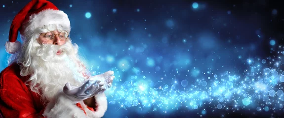 Foto op Canvas Santa Claus Blowing Magic Christmas Stars In Snowy Night   © Romolo Tavani