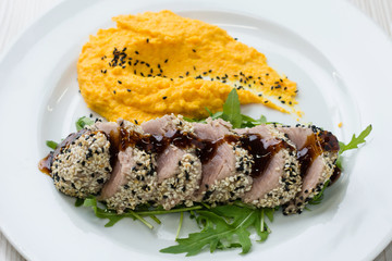 Tuna steak with sesame seeds and  mashed sweet potatoes