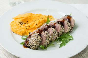 Tuna steak with sesame seeds and  mashed sweet potatoes