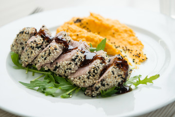 Tuna steak with sesame seeds and  mashed sweet potatoes
