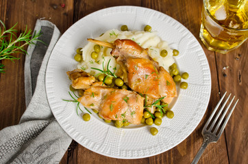 Oven Baked rabbit legs with potatoes and rosemary