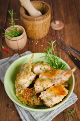 Oven Baked rabbit legs with potatoes and rosemary