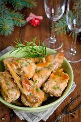 Oven Baked rabbit legs with potatoes and rosemary