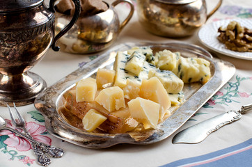Assorted cheeses on a silver platter