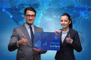 Businessman and businesswoman discussing trading strategies