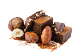 Chocolate blocks with cocoa beans and nuts isolated on white background.