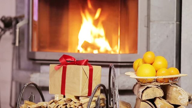 Beautiful fireplace decorated by gift and orange for Christmas