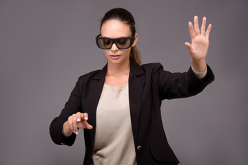 Fototapeta premium Young woman businesswoman pressing virtual buttons