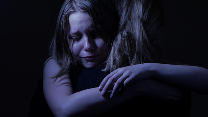 Sad teenager daughet and her loving mother.