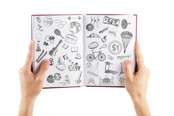 Male hands holding notebook with drawings on white background. Creative concept.