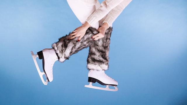Woman legs wearing ice skates fur socks, skating