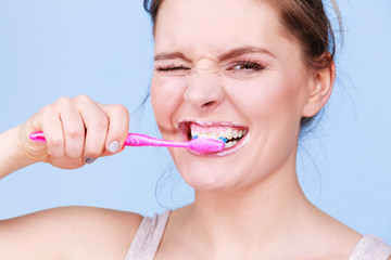 Woman brushing cleaning teeth