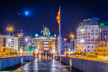 Night view of the ancient stone bridge in the macedonian capital skopje leading to the macedonia square dominated by statue of alexander the great.