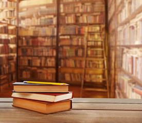 Stack of books on table at library