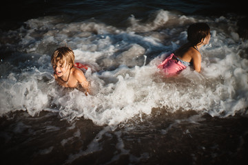 kids playing in waves