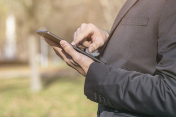 Closeup of a business men working in park 