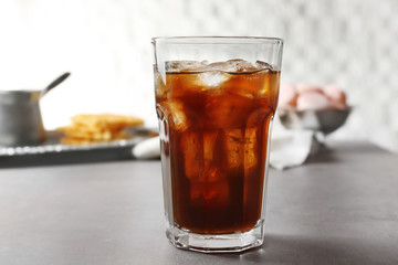 Glass of cold coffee on table