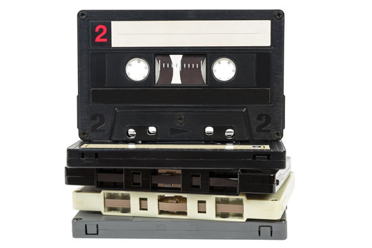Stack of vintage audio tapes on white background