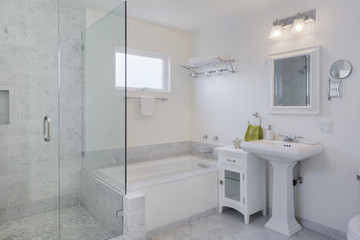 Modern marble tile bathroom with an open walk-in glass shower and bathtub