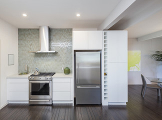 Modern kitchen interior in white. Kitchen Design concept with new stainless steel appliances.