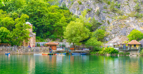 Restaurant and saint andrea monastery situated near dam of matka lake in macedonia. - obrazy, fototapety, plakaty