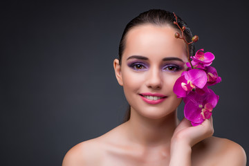 Naklejka premium Young beautiful woman with orchid flower