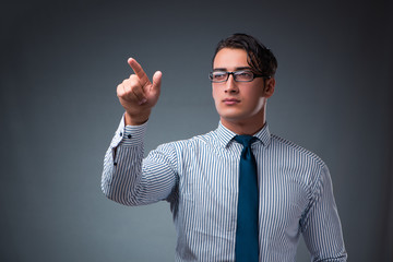 Handsome businessman pressing virtual buttons