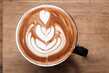 Top view of hot coffee on wooden table